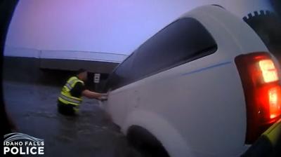 WATCH: Body camera footage shows officers rescuing woman and young child as water quickly rises around van